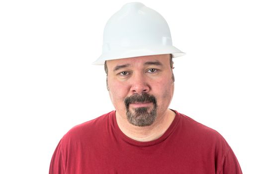 Workman or technician with a goatee beard wearing a white hardhat standing looking directly at the camera, isolated on white