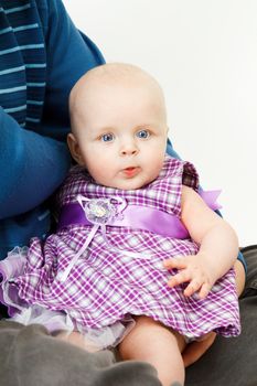 beautiful half-year-old baby girl on the hands of his father