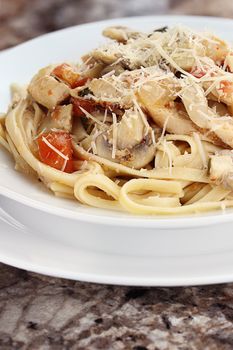 Chicken linguine with grilled chicken, tomatoes, mushrooms and freshly grated parmesan cheese.