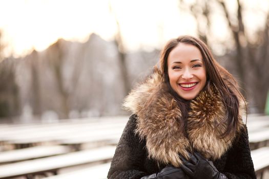 Happy and healthy smiling woman during the winter in the park