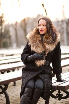 Young business lady in the park is enjoying winter