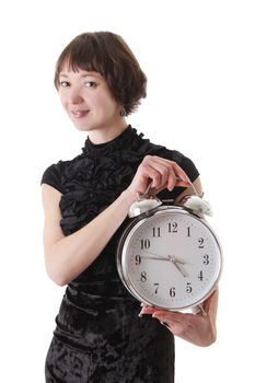 Brunette woman in dress holding clock over white