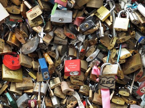 A love lock is a padlock which sweethearts lock to a bridge to symbolise their love and usually their' names or initials are inscribed on it. The key is then thrown away to symbolise unbreakable love.