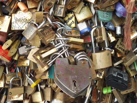 A love lock is a padlock which sweethearts lock to a bridge to symbolize their love and usually their' names or initials are inscribed on it. The key is then thrown away to symbolise unbreakable love.
