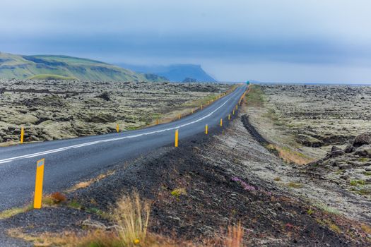 Highway through Iceland landscape at foggy day. Horizontal shot