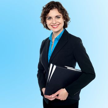 Attractive female assistant holding files