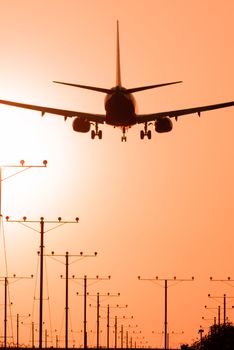 Airplane landing at Los Angeles International Airport during sunset, Los Angeles, California, USA