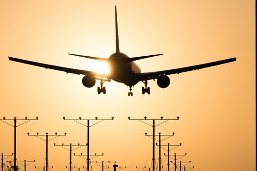 Airplane landing at Los Angeles International Airport during sunset, Los Angeles, California, USA