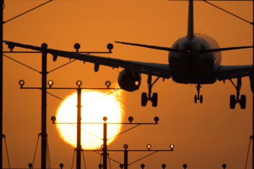 Airplane landing at Los Angeles International Airport during sunset, Los Angeles, California, USA