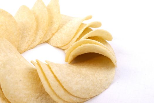 Tasty potato crisps (chips) isolated on a white background