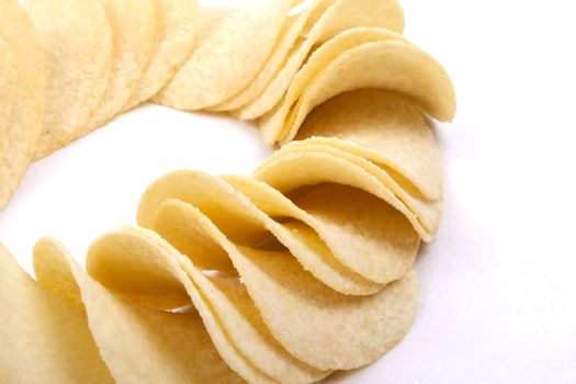 Tasty potato crisps (chips) isolated on a white background