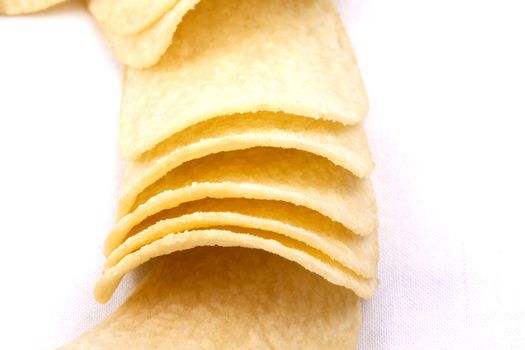 Tasty potato crisps (chips) isolated on a white background