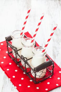 Milk in bottles with paper straws for children