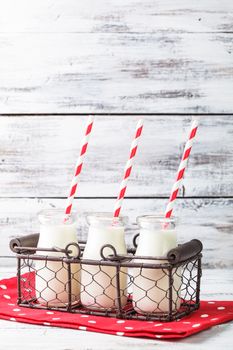 Milk in bottles with paper straws for children