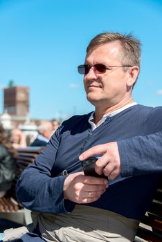 Middle Aged Man Relaxing on bench