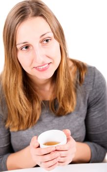 Happy girl in grey holding mug and not looking at camera with smile