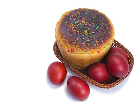 Easter eggs are dyed red , and Easter bread in a wicker basket. Presented on a white background.