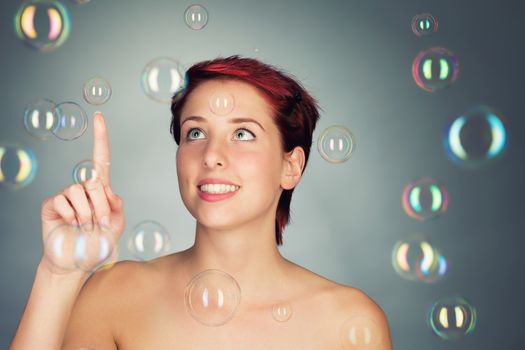 beautiful young woman playing with soap bubbles