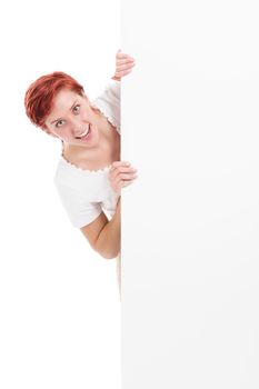 young woman looking excited from behind a white board