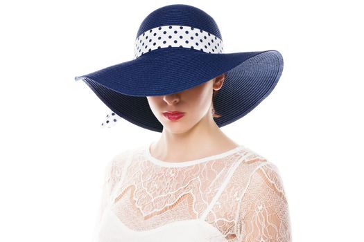 young woman hiding her eyes under a sun hat on white background