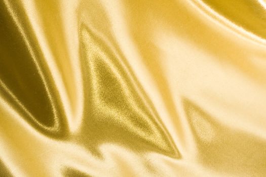 Golden satin or silk background with beautiful waves