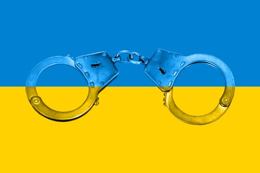 Concept of National Ukrainian Flag and Handcuffs