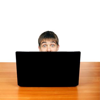 Surprised Teenager behind Laptop. Isolated on the White Background