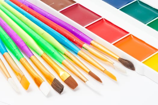 Set of artistic brushes and paints on white background