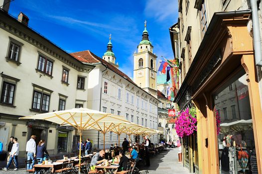 LJUBLJANA, SLOVENIA - SEPTEMBER 02, 2013: People at street cafe in old town of Ljubljana, Slovenia. This year Ljubljana city is competing for the title of European Green Capital 2016 