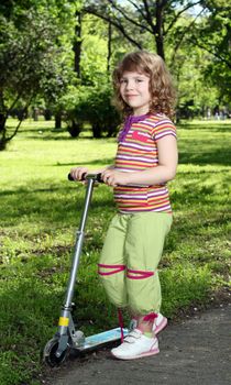 little girl with scooter in park