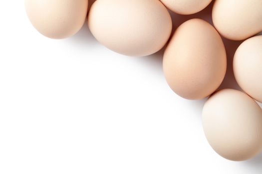 Chicken eggs on white background with empty room for text. Top view