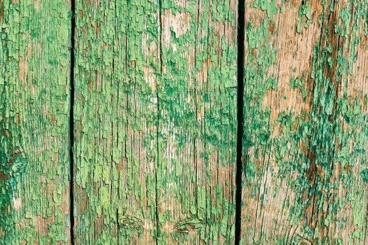 Old cracked green paint on wooden surface textured background