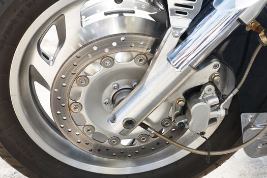 Front wheel with brake disc and braking system of a big chrome-plated motorcycle