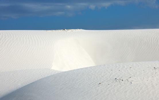 Desert scenery with white quartz sand and blue sky