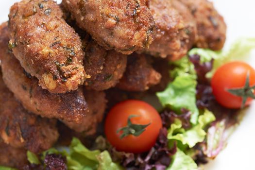 French mediterranean meat rissoles with vegetable garnish