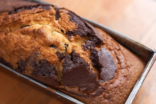 Rosted cake in square pan on table