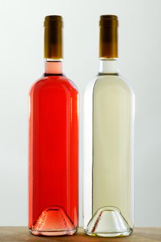Two bottles of red and white wine, sealed, without labels