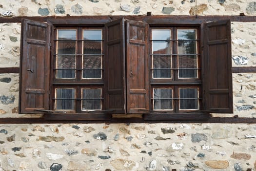 Windows of ancient stone house in Zlatograd town, Bulgaria
