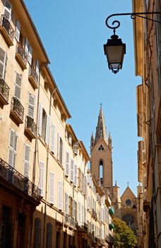 Typical street architecture in Aix en Provence, France with cathedral tower