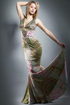 Fashion studio shoot with young model woman, pretty girl in long dress