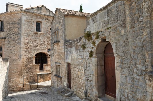 Street with ancient stone buildings in village Les Baux de Provence, South France