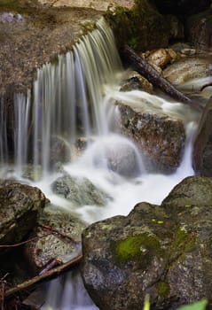 Water of a mountain stream current, running on stones