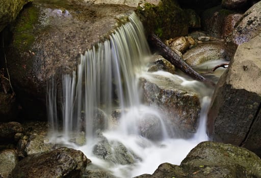 Smooth water of a mountain stream waterfall