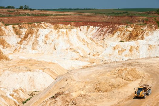 Limestone quarry with white material and truck