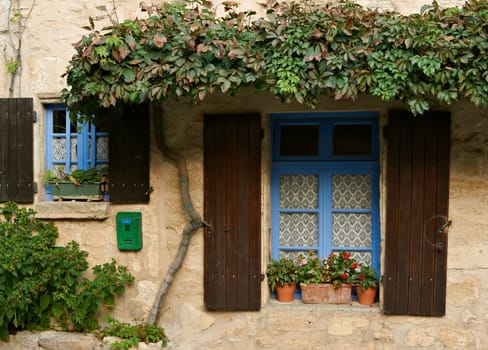 Windows od old traditional house in village of Cucuron, French Provence
