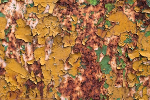 Old peeled random colors paint on rusty metal backgound