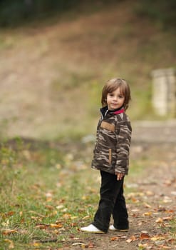 Portrait of a little boy in autumn forest