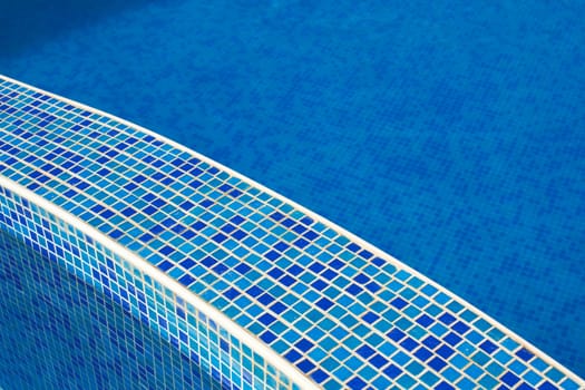 Blue water in a pool with tiles