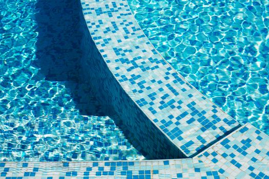 Blue water in a pool with tiles