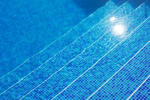 Blue tiles of a swimming pool stairs